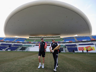 Andrew Strauss and coach Andy Flower arrive for a nets session at Sheikh Zayed Stadium