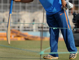 India captain MS Dhoni inspects the wicket ahead of a Test match 