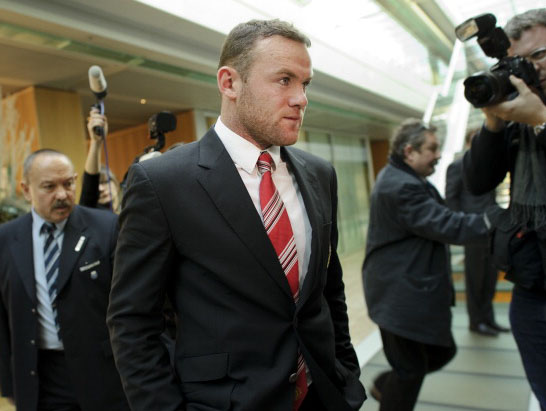 Wayne Rooney simply can't pull off looking smart despite wearing a suit to a meeeting with Uefa. 