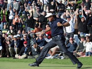 Phil Mickelson delivers his trademark fist pump after birdying the last to get into the play off