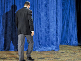 Tiger Woods exits the stage after Friday's public apology