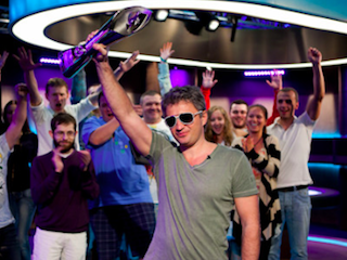 Leonid Bilokur hoists the winner's trophy after taking down the 2012 PCA High Roller (Photo: PokerNews)