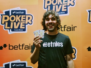 Juan Bel shos off his winning hand