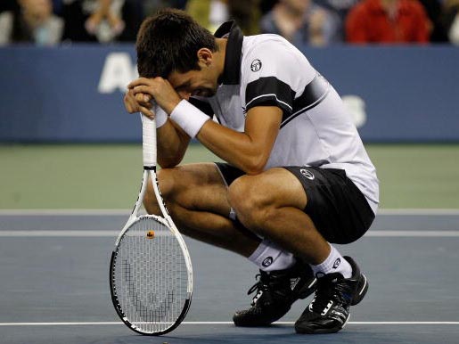 An exhausted and disconsolate Novak Djokovic after his defeat to Nadal in the US Open final