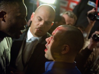Chisora with Haye's wounded manager Adam Booth