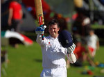 Graeme Swann raises his bat after reaching 50; his knock of 85 put England right back in the game.