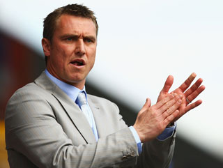 Lee Clark watches his Huddersfield side during their defeat to Millwall in last season's play-offs 