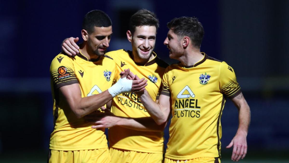 Sutton United players celebrate a goal