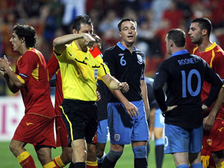 You're off, son. Wayne Rooney sees red and kicks out before seeing red for kicking out. 