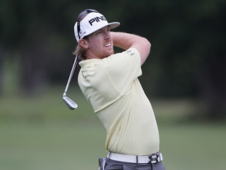 Hunter Mahan plays his second to 18 after narrowly avoiding the water with his drive