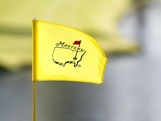 A Masters flag flutters in the wind during Monday’s practice day