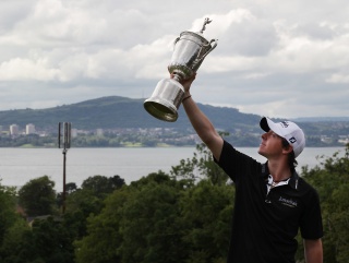Rory holds his trophy aloft - there will be more