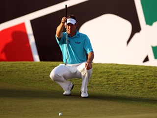 Lee Westwood attempts to line-up another putt from short distance