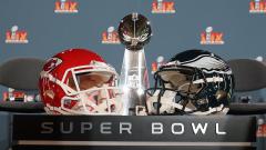 The Super Bowl trophy and Kansas City Chiefs and Philadelphia Eagles helmets