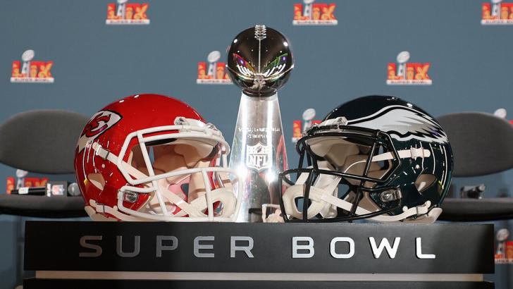 The Super Bowl trophy and Kansas City Chiefs and Philadelphia Eagles helmets
