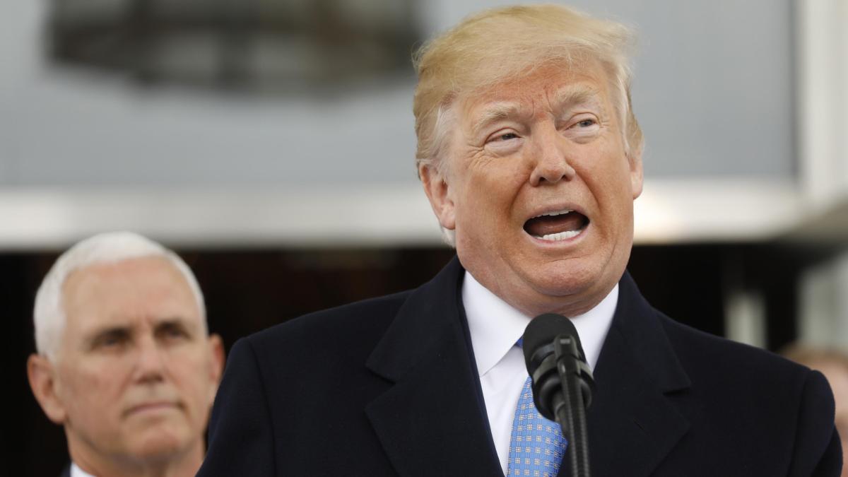 US president Donald Trump with VP Mike Pence in background