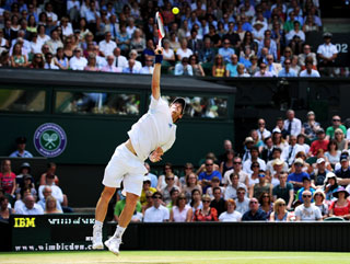Murray serves on his way to victory in searing London sunshine