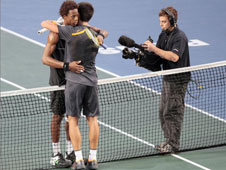 Novak Djokovic (pictured with his back to the camera) embraces Gael Monfils after an epic final in the Paris Masters, which the Serb won. 