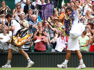 Nadal somewhat apologetically salutes the crowd after he knocks out their darling in 2010 but this year it could all be different